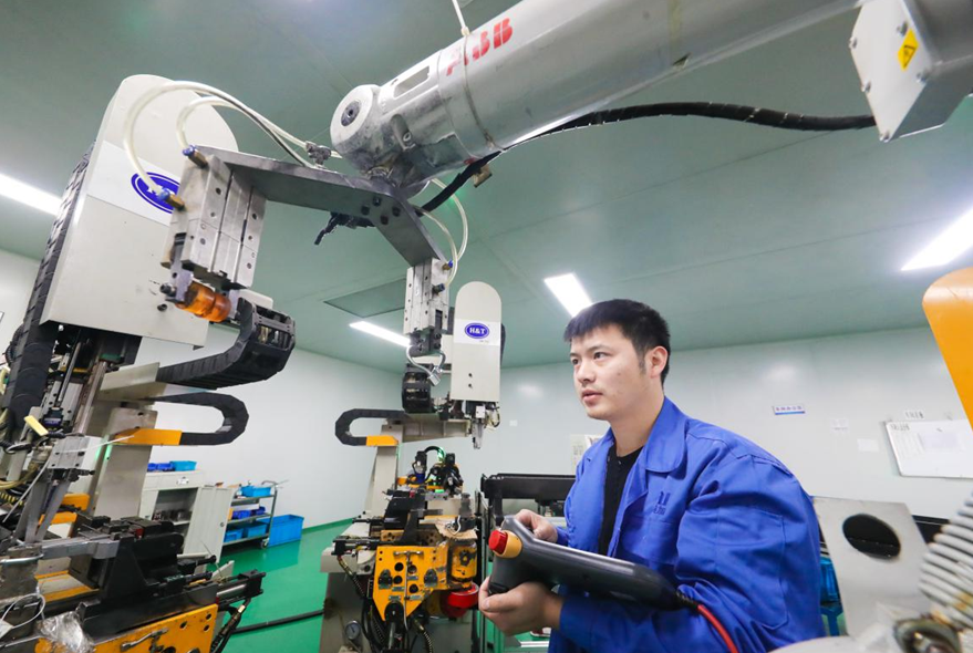 A worker manufactures products to be shipped overseas at an auto parts company.png A worker manufactures products to be shipped overseas at an auto parts company.png
